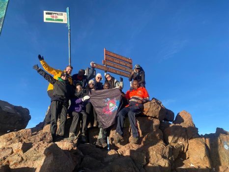 Group of volunteers at mountain peak