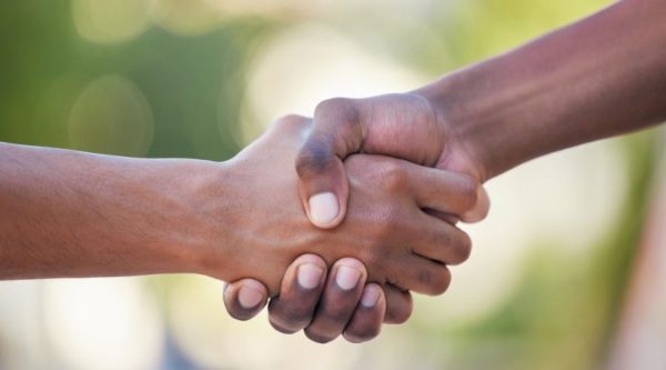 Two people shaking hands in agreement